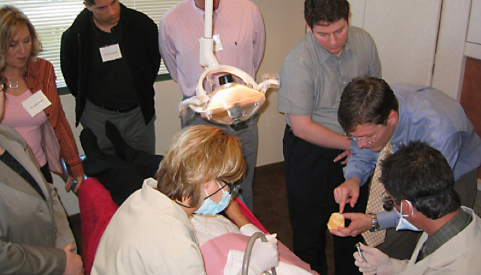 Dentists observing a live-patient course